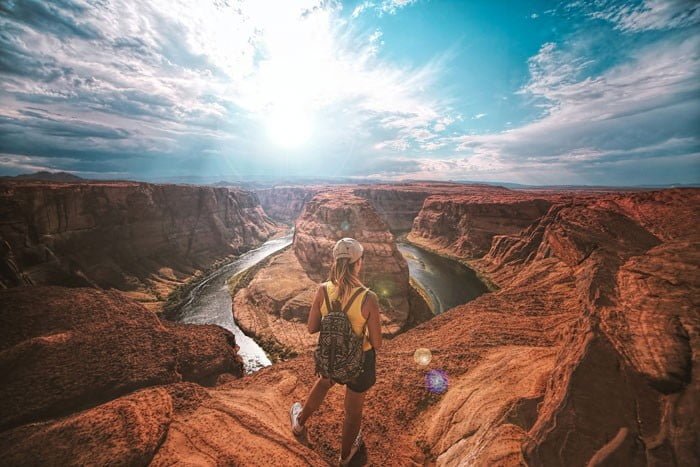 woman traveling, standing on top of a canyon