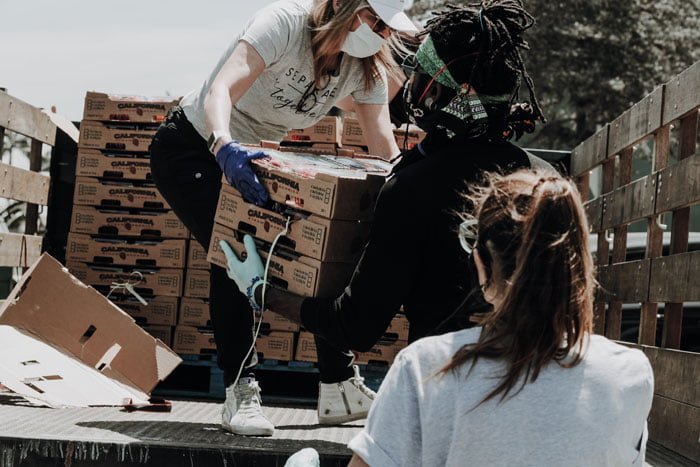 group of young people help with food donation