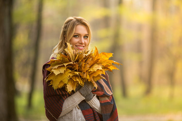 Woman outside with leaves