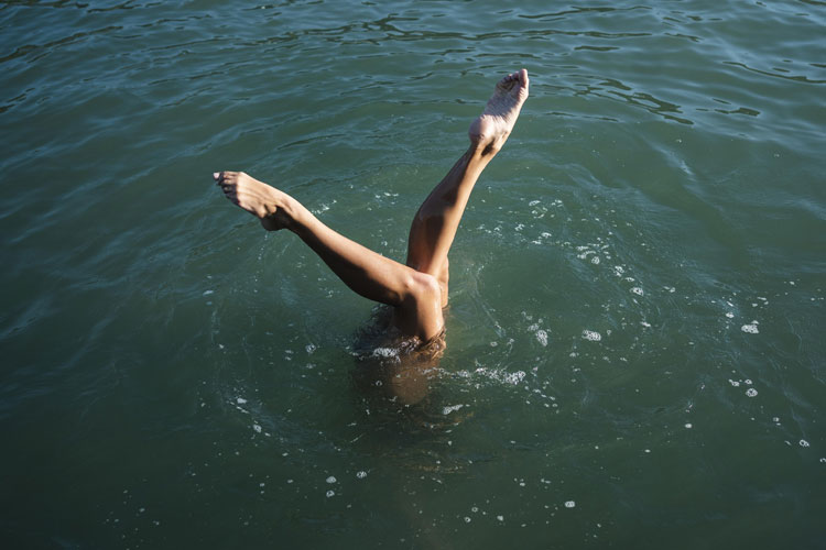 human legs out of lake water 